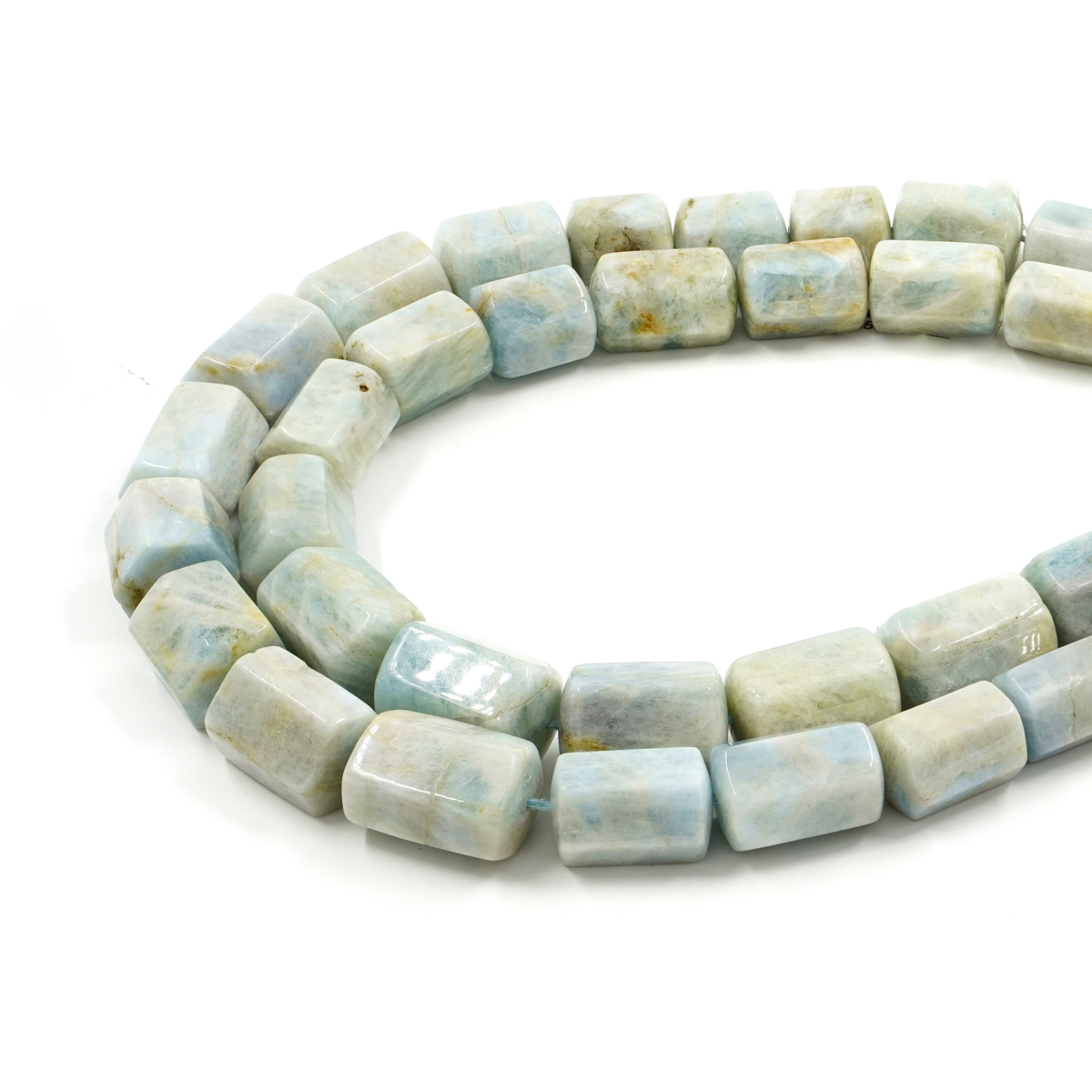 Aquamarine strands graduated hexagonal cylinders