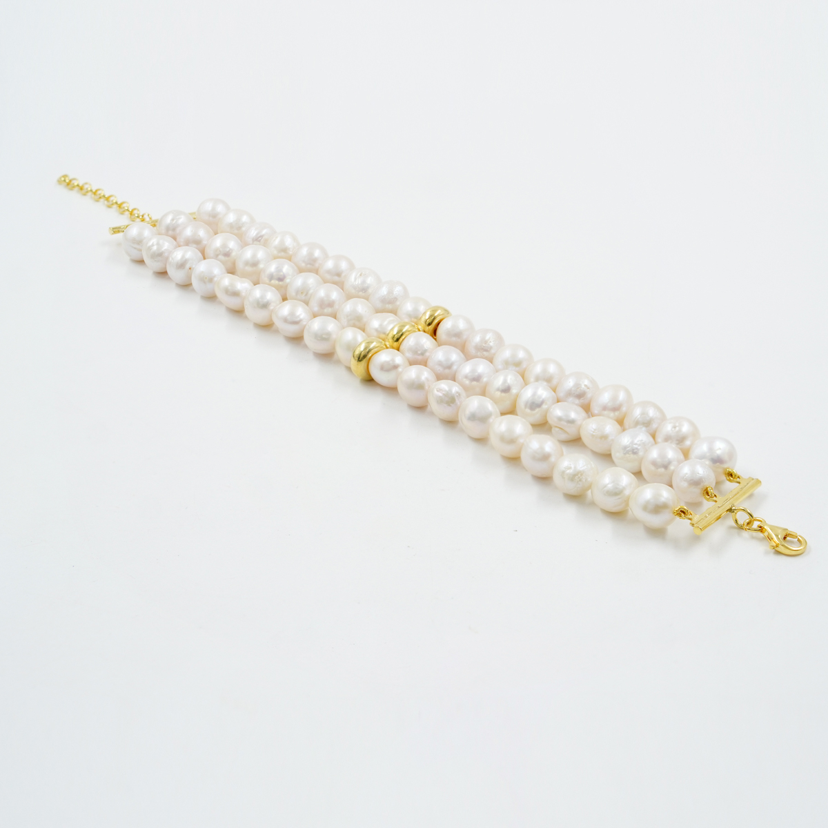 Multistrand bracelet with edison pearls, golden color silver clasp and element