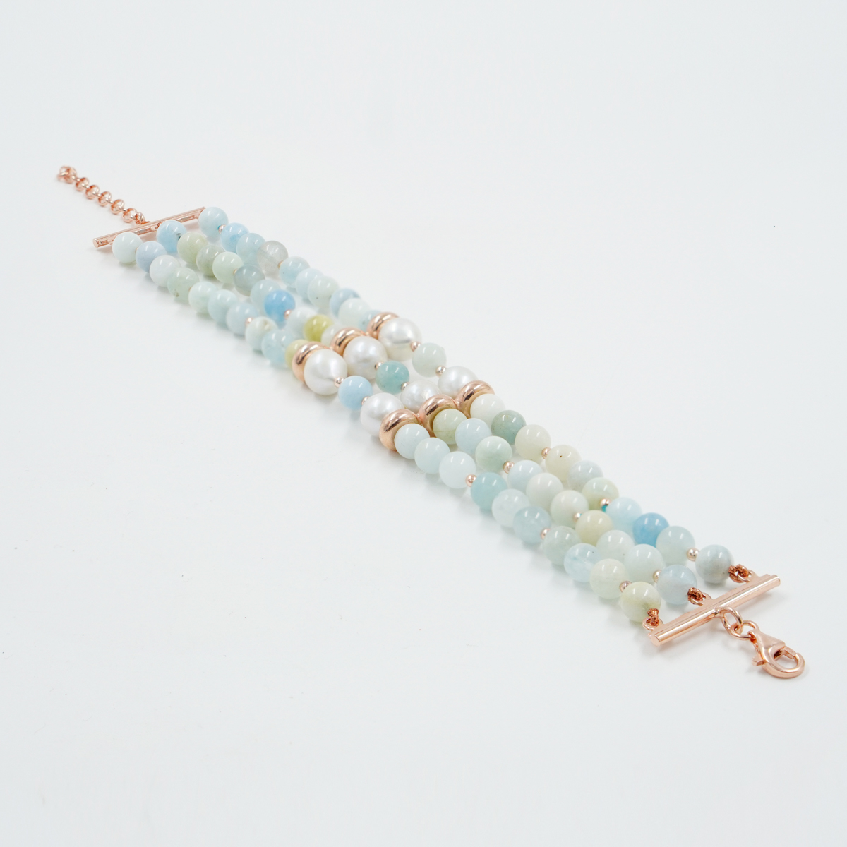 Multistrand bracelet with aquamarine, pearl, rose color silver clasp
